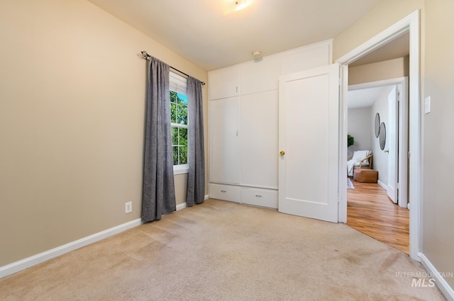 unfurnished bedroom featuring light colored carpet