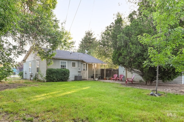 back of house with a lawn