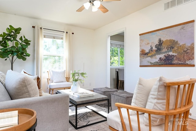 sitting room featuring ceiling fan and light wood-type flooring