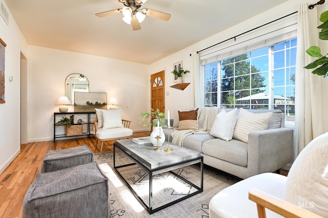 living room featuring hardwood / wood-style flooring and ceiling fan