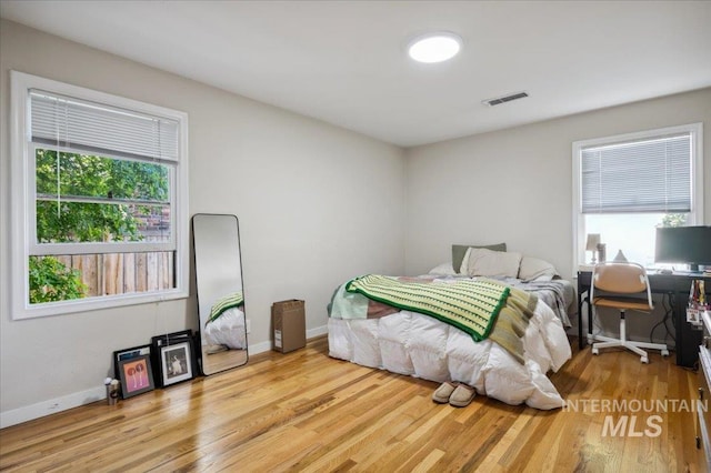 1207 N 19th St, Boise, ID 83702 - bedroom featuring multiple windows, baseboards, and wood finished floors