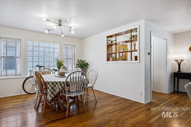 1207 N 19th St, Boise, ID 83702 - dining area featuring wood finished floors, a chandelier, and a textured ceiling