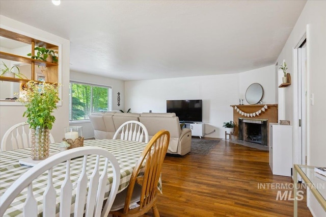 1207 N 19th St, Boise, ID 83702 - dining area featuring wood finished floors and a fireplace with flush hearth