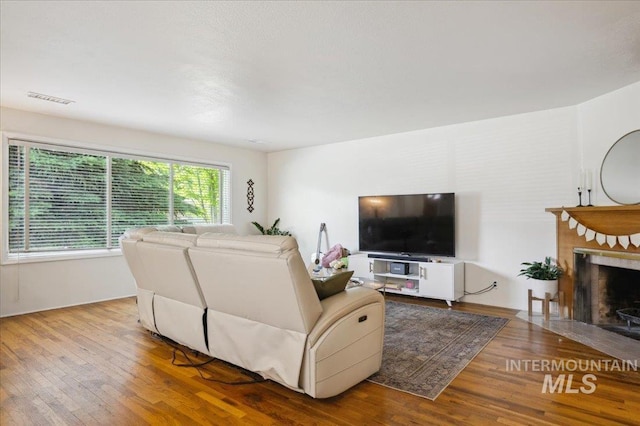 1207 N 19th St, Boise, ID 83702 - living room featuring wood finished floors and a fireplace with flush hearth