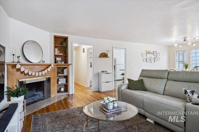 1207 N 19th St, Boise, ID 83702 - living area featuring wood finished floors and a fireplace with flush hearth