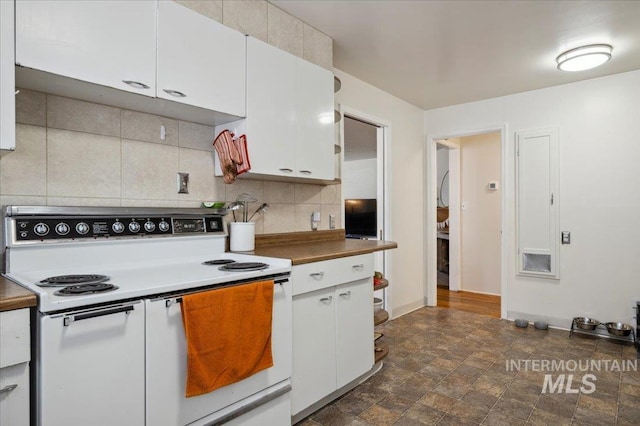 1207 N 19th St, Boise, ID 83702 - kitchen with white range with electric stovetop, decorative backsplash, white cabinetry, baseboards, and stone finish flooring