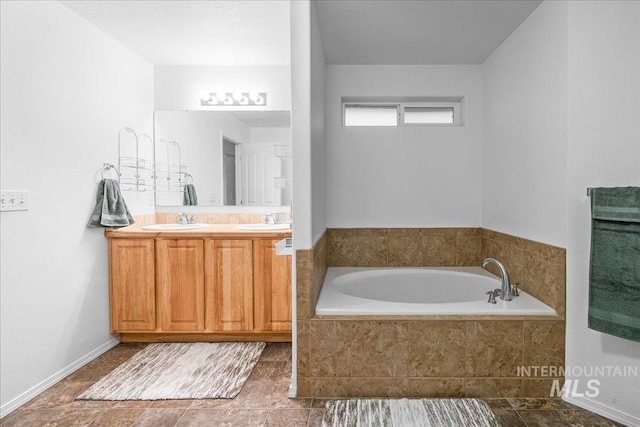 bathroom with vanity and tiled tub