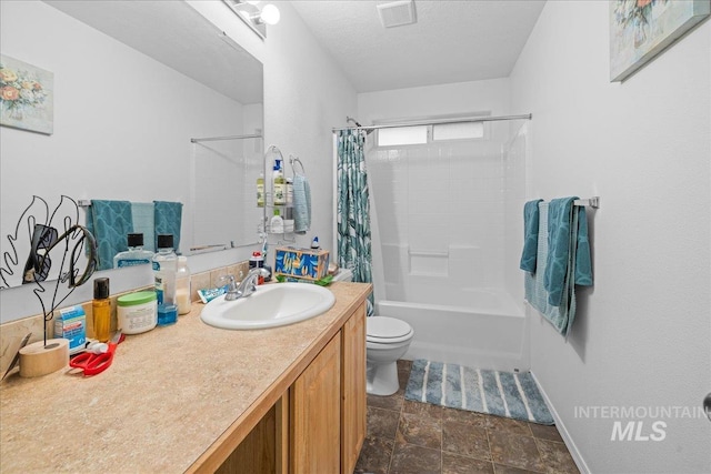 full bathroom with shower / tub combo with curtain, vanity, a textured ceiling, and toilet