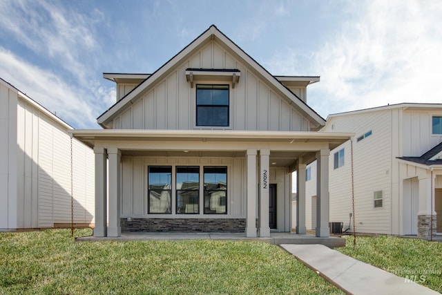 2827 N Rocky Bottom Way, Kuna, ID 83634 - view of front facade featuring board and batten siding, a porch, a front lawn, and stone siding