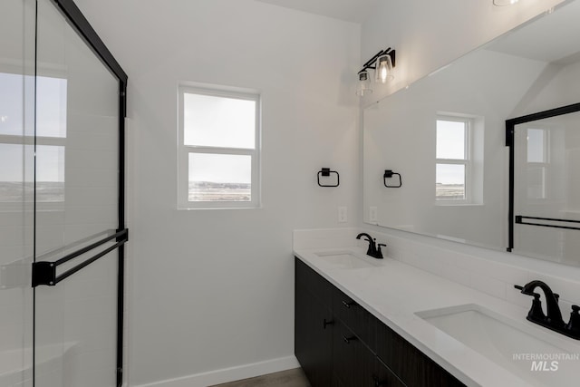 2827 N Rocky Bottom Way, Kuna, ID 83634 - full bathroom featuring double vanity, a shower with shower door, and baseboards