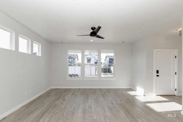 2827 N Rocky Bottom Way, Kuna, ID 83634 - spare room with light wood-style flooring, a ceiling fan, and baseboards