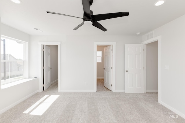 2827 N Rocky Bottom Way, Kuna, ID 83634 - unfurnished bedroom with a spacious closet, light carpet, baseboards, and a ceiling fan