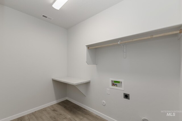 2827 N Rocky Bottom Way, Kuna, ID 83634 - laundry room with electric dryer hookup, light wood-type flooring, baseboards, and hookup for a gas dryer