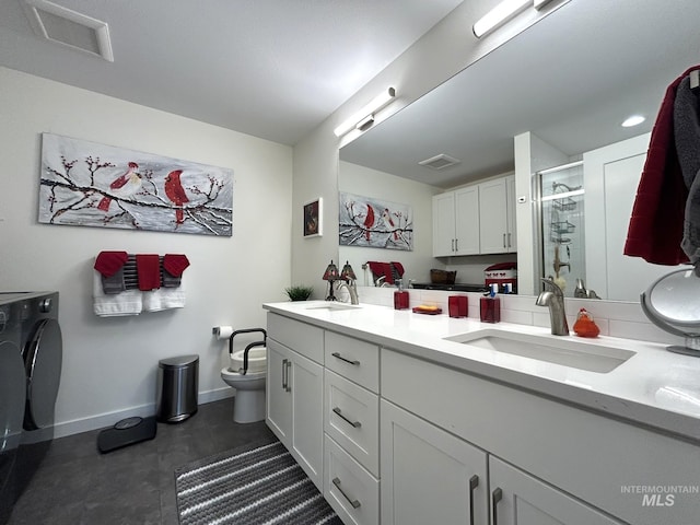 bathroom featuring a shower stall, double vanity, visible vents, and a sink