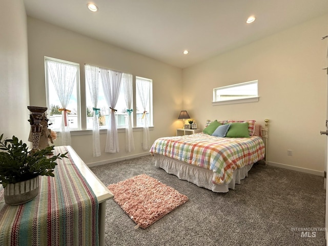 carpeted bedroom featuring multiple windows, recessed lighting, and baseboards