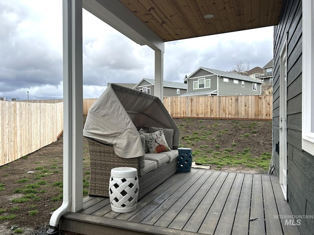 wooden terrace featuring a fenced backyard