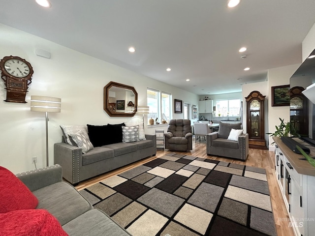 living area with recessed lighting and light wood-type flooring