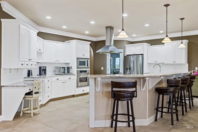 kitchen with white cabinets, island exhaust hood, appliances with stainless steel finishes, and light stone countertops