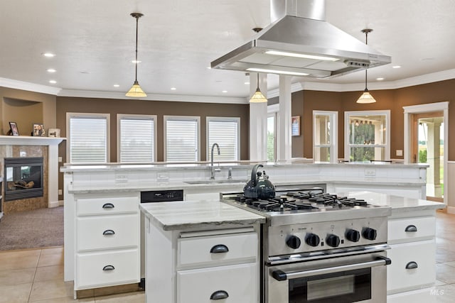 kitchen featuring high end stainless steel range oven, white cabinets, island exhaust hood, hanging light fixtures, and a kitchen island