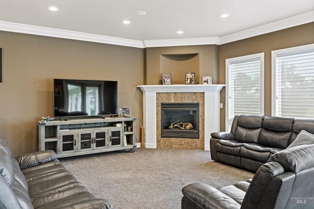 living room featuring carpet flooring, a fireplace, and crown molding