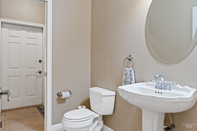 bathroom featuring sink, tile patterned flooring, and toilet