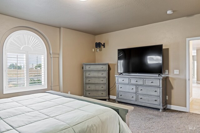 carpeted bedroom featuring a textured ceiling