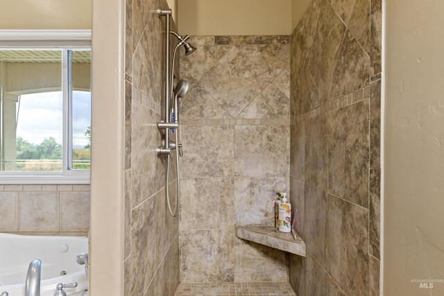 bathroom featuring independent shower and bath