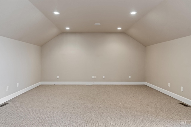 bonus room featuring vaulted ceiling and carpet flooring