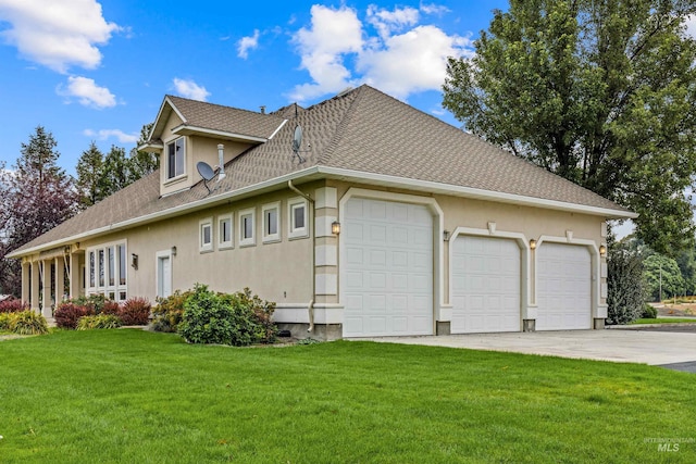 view of side of home featuring a lawn and a garage