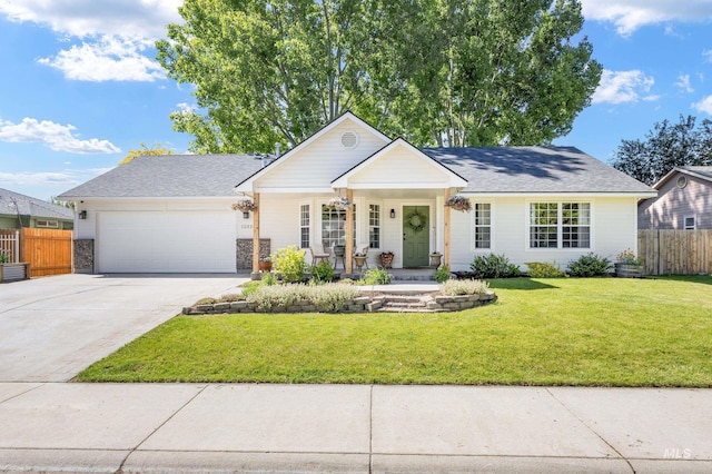 1233 N Tumbler Dr, Kuna, ID 83634 - view of front of home featuring a garage, driveway, covered porch, and roof with shingles