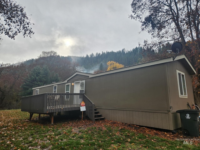 back of house with a wooden deck