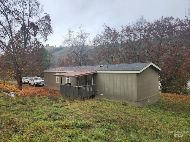 rear view of house featuring a lawn