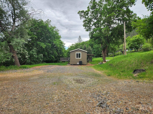 135 N Marion St, Peck, ID 83545 - view of yard featuring a deck and view of wooded area