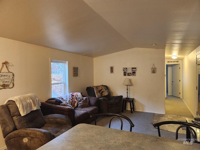 carpeted living room with lofted ceiling and a textured ceiling