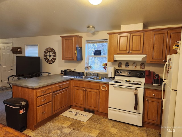 kitchen featuring kitchen peninsula, white appliances, and sink