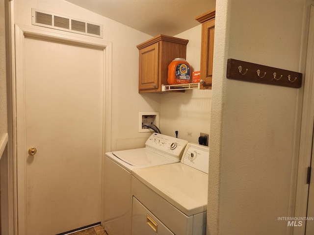 laundry room featuring cabinets and washing machine and clothes dryer