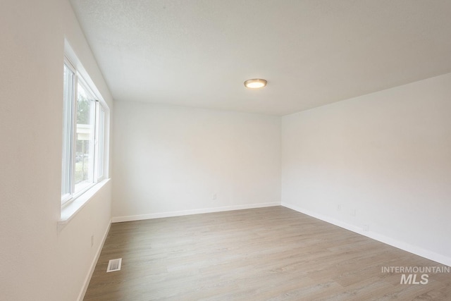 unfurnished room with light hardwood / wood-style floors