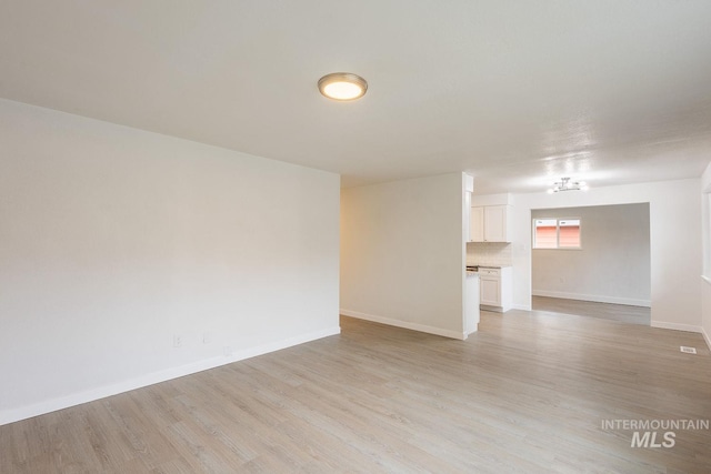 unfurnished room with light wood-type flooring