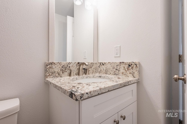 bathroom with vanity and toilet