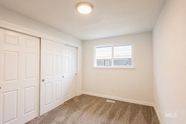 unfurnished bedroom featuring a closet and carpet