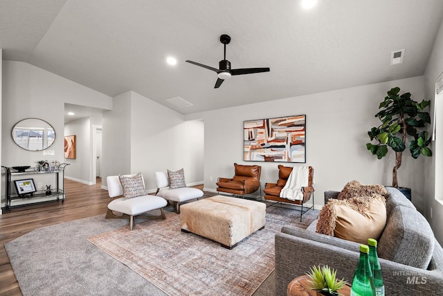 living room featuring wood finished floors, baseboards, visible vents, lofted ceiling, and ceiling fan