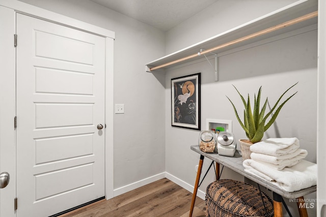 interior space with baseboards and wood finished floors