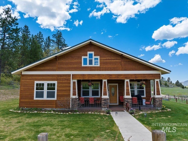 view of front of home with a porch and a front yard