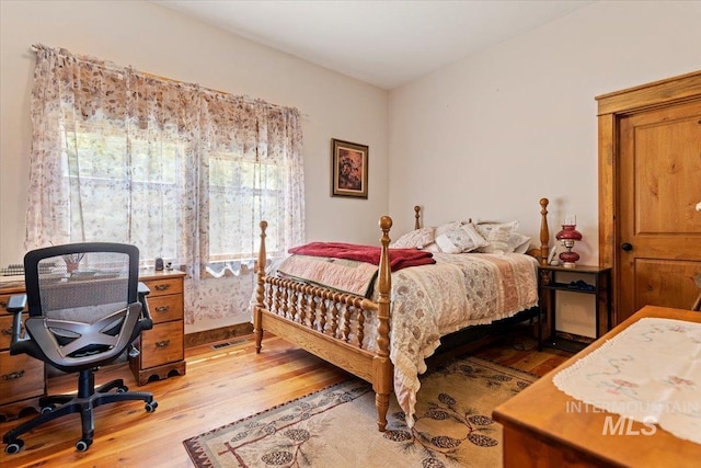 bedroom with hardwood / wood-style floors