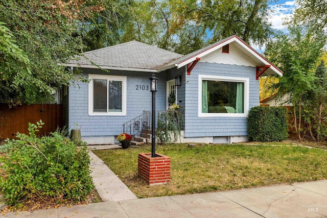 bungalow-style home with a front lawn