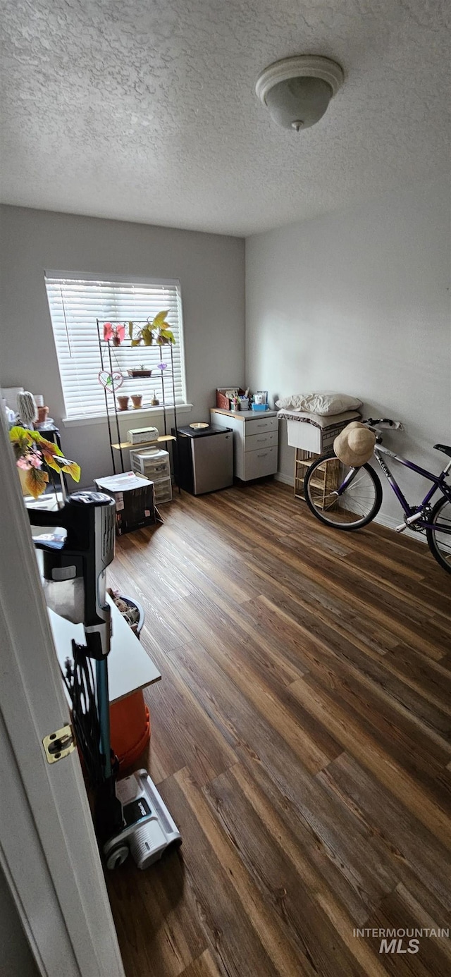 misc room featuring a textured ceiling and wood finished floors