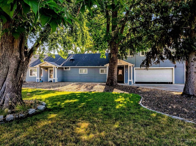 ranch-style house with a garage and a front lawn