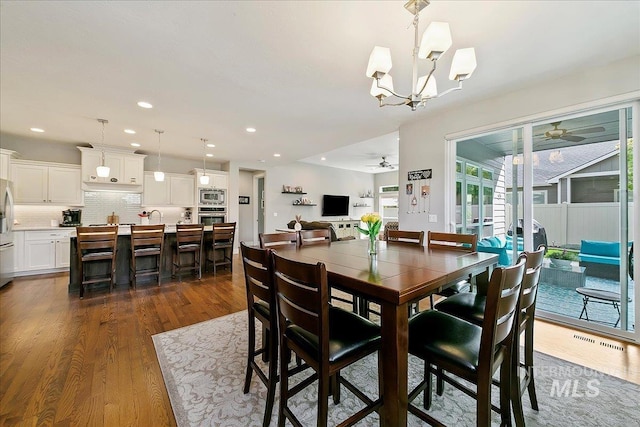 5726 N Morpheus Way, Meridian, ID 83642 - dining room with a ceiling fan, dark wood-style floors, a chandelier, and recessed lighting