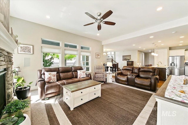 5726 N Morpheus Way, Meridian, ID 83642 - living area with ceiling fan, a fireplace, and recessed lighting