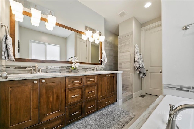 5726 N Morpheus Way, Meridian, ID 83642 - bathroom featuring tasteful backsplash, double vanity, and tiled shower